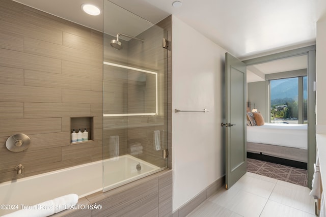 bathroom with tile patterned floors and bath / shower combo with glass door