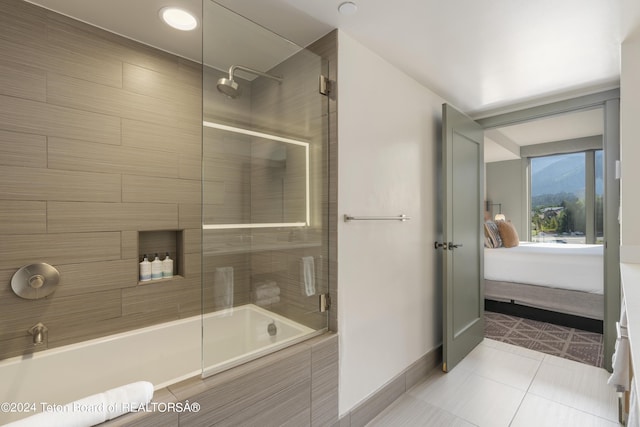 bathroom with tile patterned floors and combined bath / shower with glass door