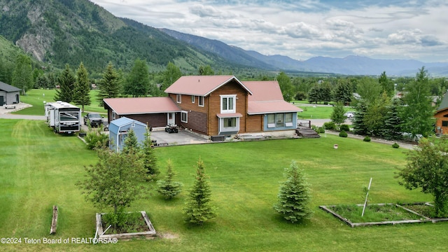 birds eye view of property featuring a mountain view