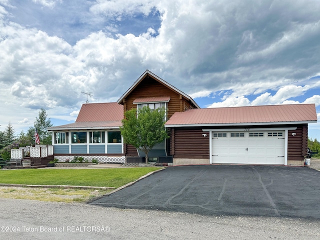 view of front facade with a garage and a front lawn