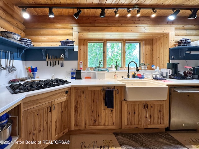 kitchen with black gas cooktop, sink, dishwasher, and log walls