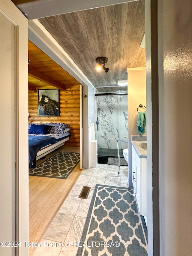 bathroom with vanity, wood-type flooring, log walls, toilet, and wood ceiling