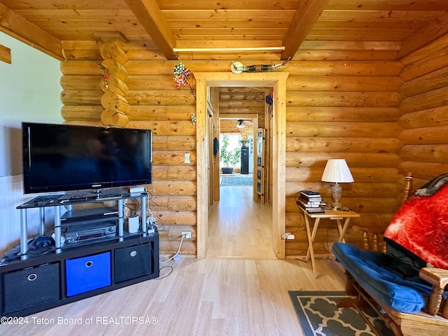 living room featuring wooden ceiling, hardwood / wood-style flooring, beamed ceiling, and rustic walls