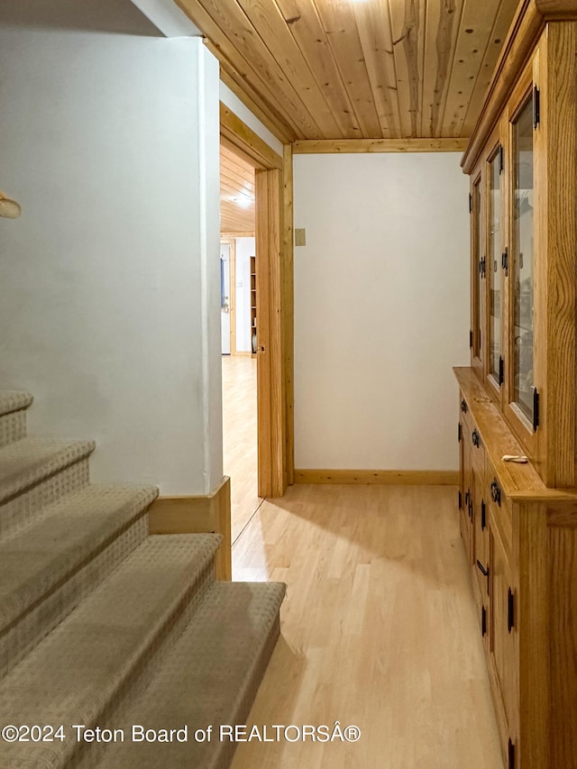 interior space with light hardwood / wood-style floors and wood ceiling