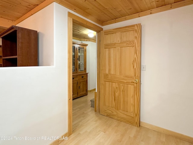 hall with wood ceiling and light hardwood / wood-style floors