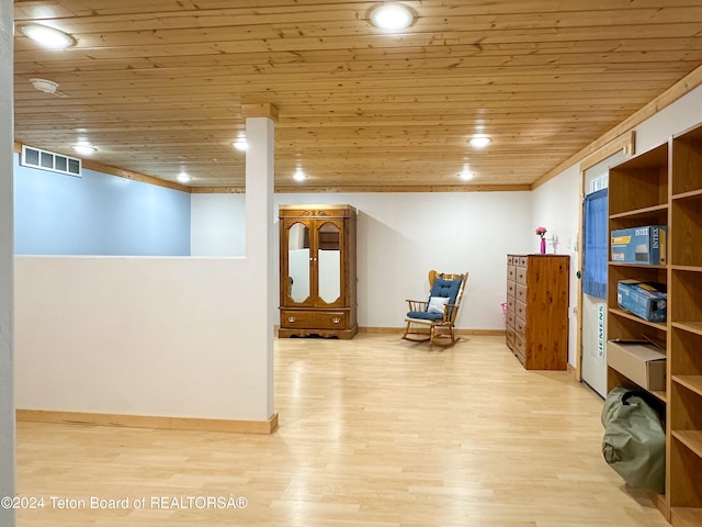 sitting room with light wood-type flooring and wood ceiling