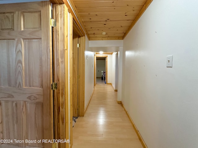 hall featuring light hardwood / wood-style floors and wood ceiling