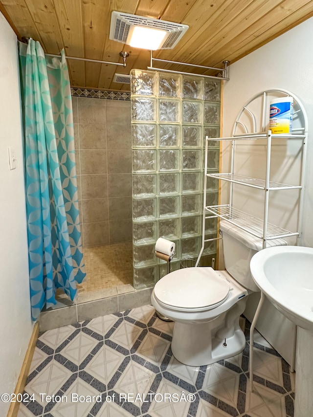 bathroom featuring tile patterned flooring, curtained shower, toilet, and wooden ceiling