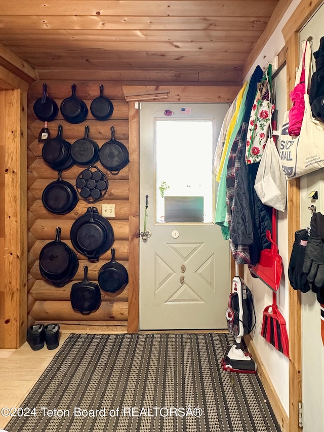 doorway with wooden ceiling, hardwood / wood-style floors, and rustic walls