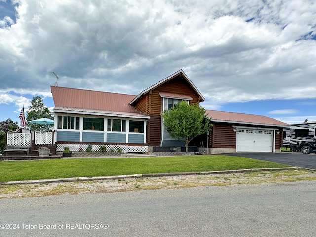 view of front of property featuring a garage and a front yard