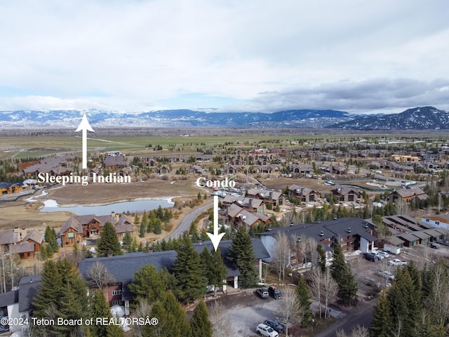 birds eye view of property with a mountain view