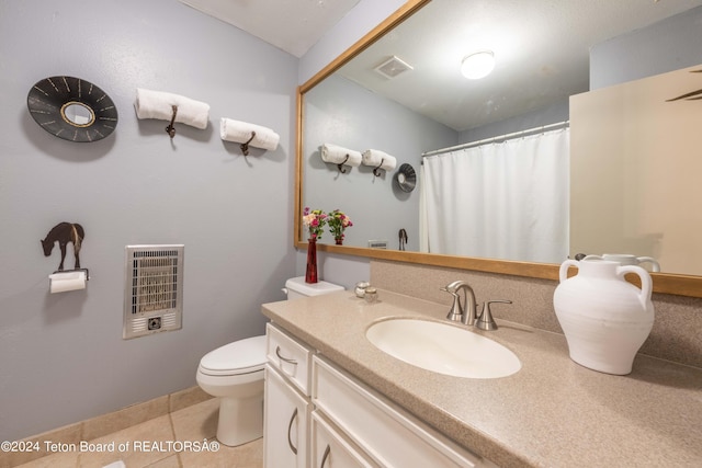 bathroom with tile patterned floors, vanity, toilet, and heating unit