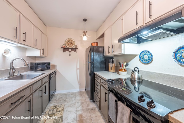 kitchen featuring white cabinetry, decorative light fixtures, sink, and black appliances