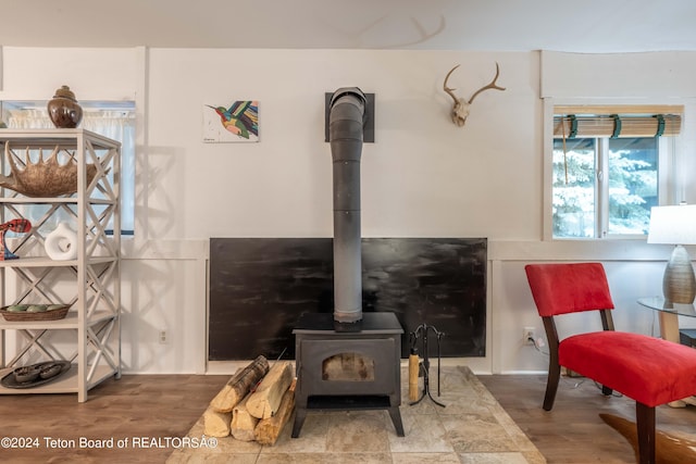 living room with hardwood / wood-style floors and a wood stove