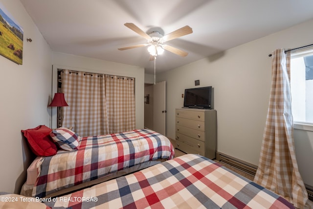 bedroom with a baseboard heating unit and ceiling fan