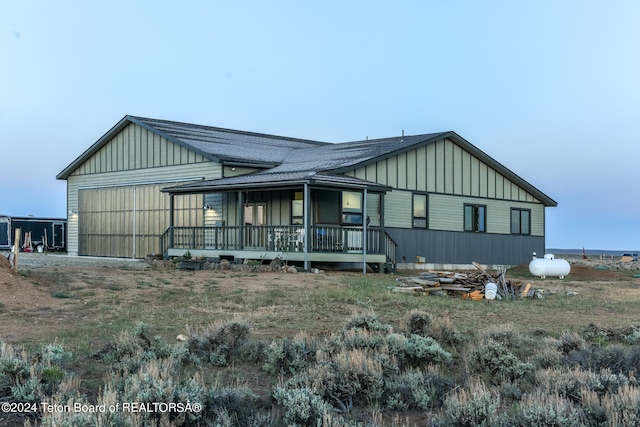 78 E Fork Big Sandy, Boulder, WY 82923 - exterior space featuring a garage, board and batten siding, a shingled roof, and a porch
