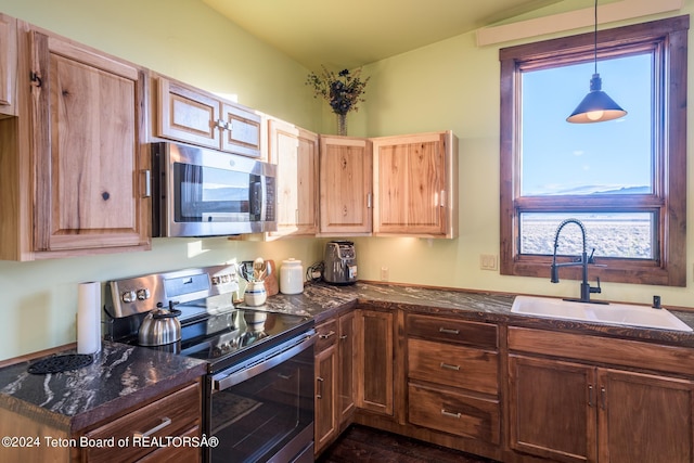 78 E Fork Big Sandy, Boulder, WY 82923 - kitchen featuring dark stone countertops, decorative light fixtures, appliances with stainless steel finishes, and a sink