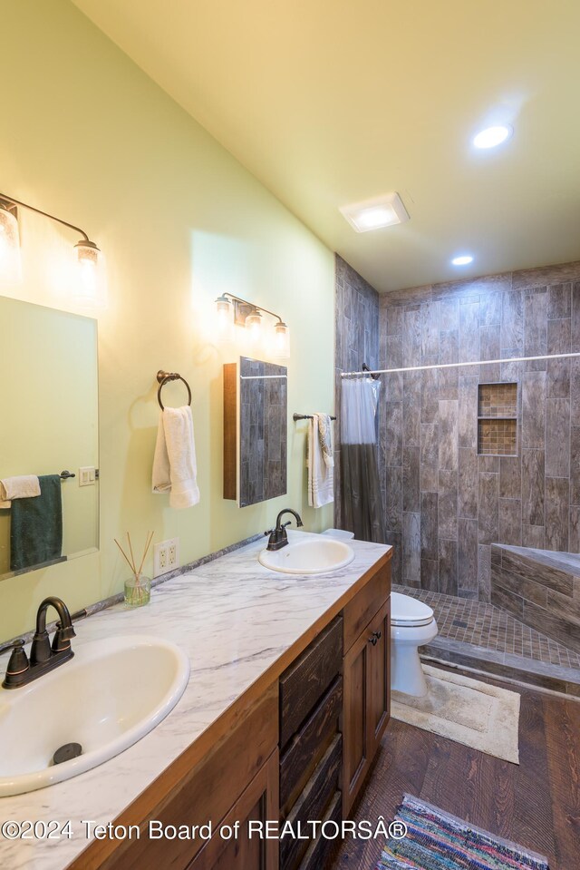 78 E Fork Big Sandy, Boulder, WY 82923 - bathroom featuring double vanity, toilet, tiled shower, and a sink