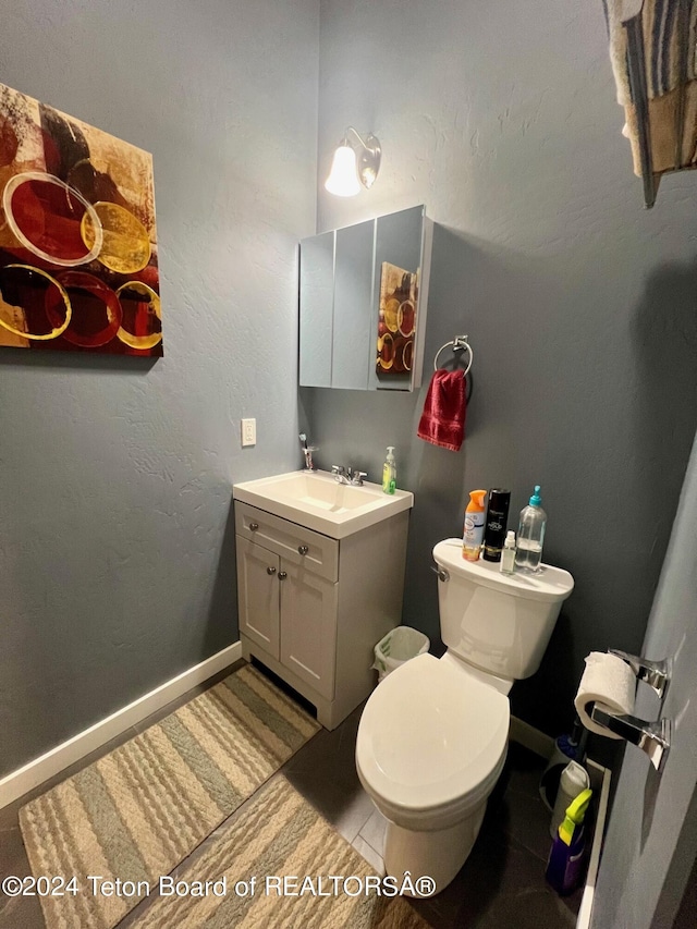 bathroom with toilet and vanity