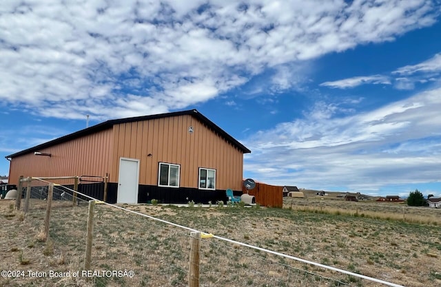 view of property exterior featuring an outbuilding