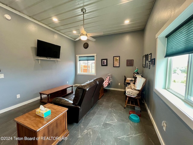 tiled living room with a healthy amount of sunlight and ceiling fan