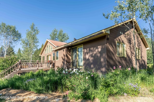 view of property exterior with a deck