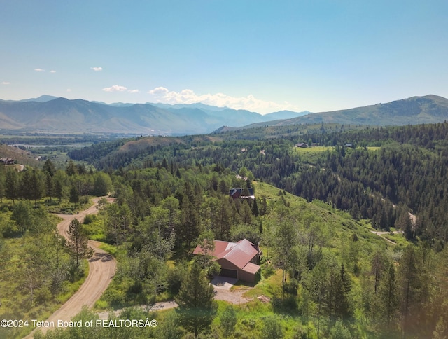 aerial view with a mountain view and a view of trees