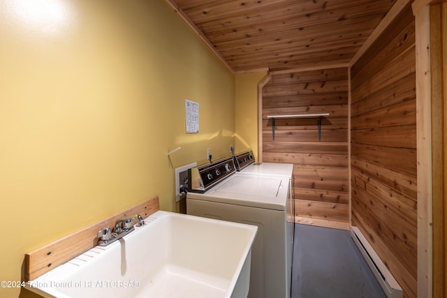 laundry area with laundry area, wooden walls, wood ceiling, separate washer and dryer, and a sink