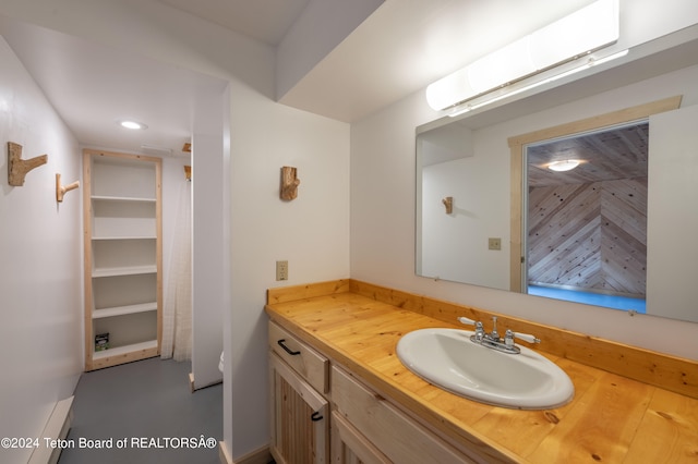 bathroom featuring recessed lighting and vanity