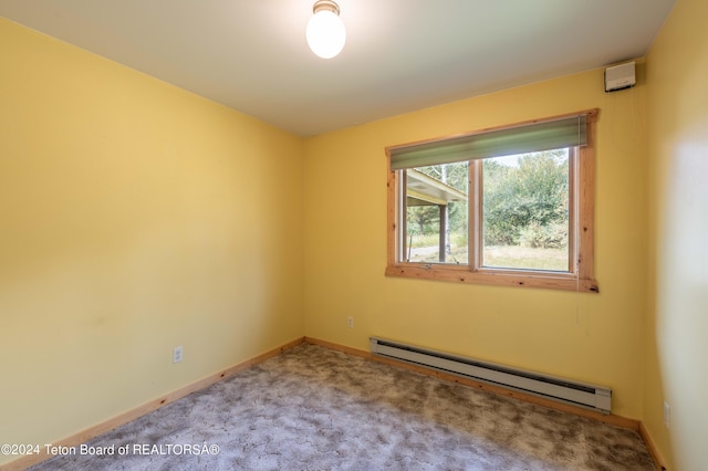 empty room with a baseboard radiator, carpet flooring, and baseboards