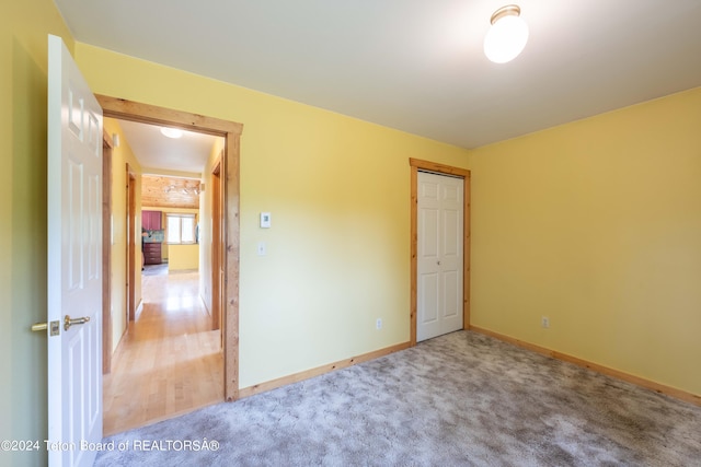 unfurnished room featuring carpet and baseboards