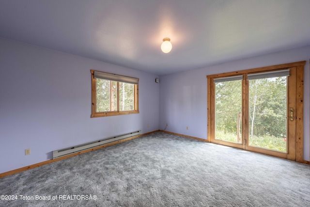 unfurnished room with carpet floors, baseboard heating, plenty of natural light, and baseboards