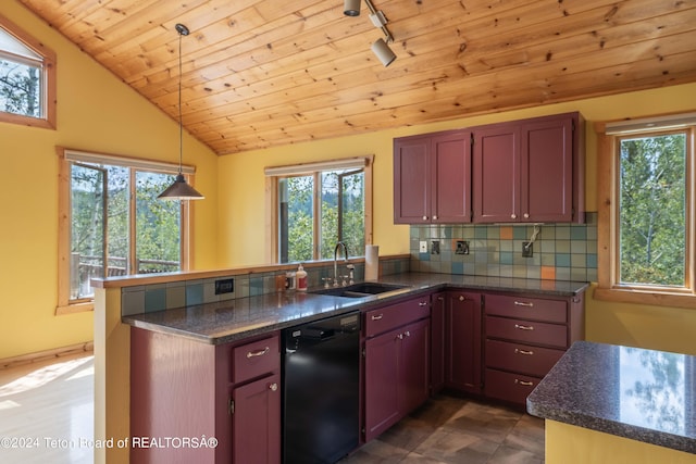 kitchen featuring a peninsula, black dishwasher, a sink, and decorative light fixtures