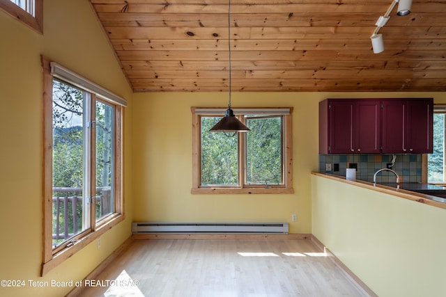 unfurnished dining area featuring light wood finished floors, a baseboard heating unit, vaulted ceiling, track lighting, and wooden ceiling