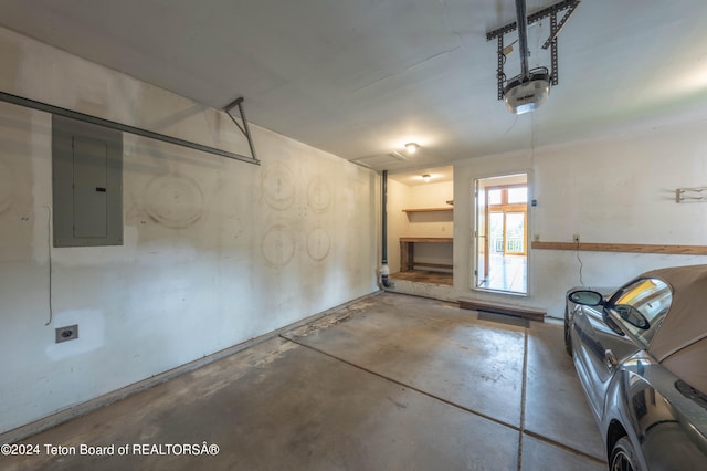 garage with electric panel and a garage door opener