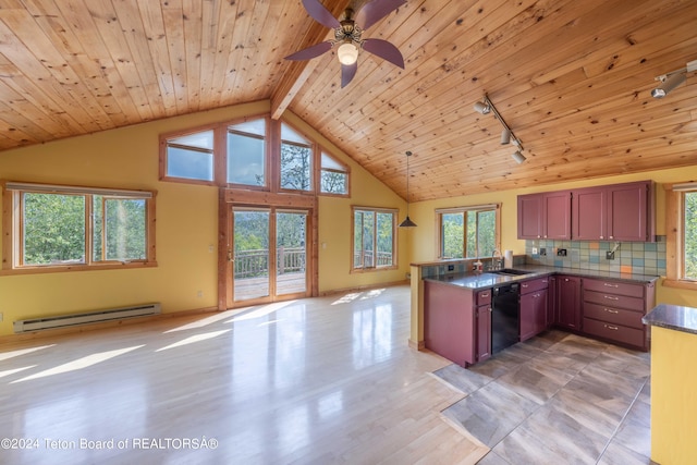 kitchen featuring dark countertops, a baseboard heating unit, open floor plan, a sink, and dishwasher