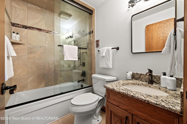 full bathroom featuring vanity, toilet, and combined bath / shower with glass door