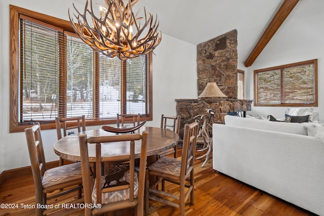 dining room with an inviting chandelier, wood-type flooring, and lofted ceiling with beams