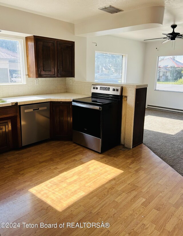 kitchen featuring ceiling fan, dishwasher, light hardwood / wood-style floors, and electric stove