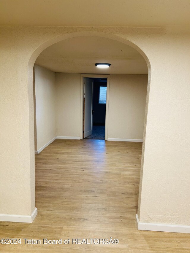 corridor with light hardwood / wood-style floors