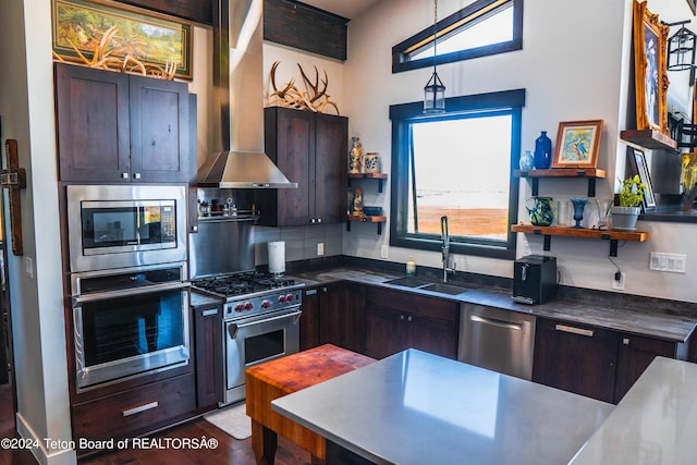 kitchen with wall chimney range hood, stainless steel appliances, decorative backsplash, sink, and dark brown cabinets