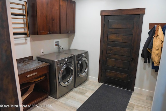 washroom with cabinets, separate washer and dryer, and light hardwood / wood-style flooring