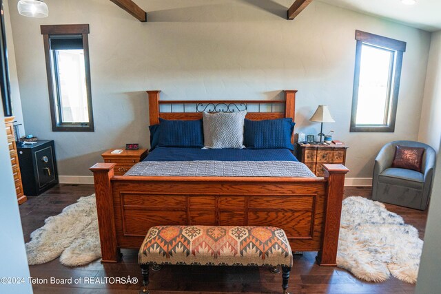 bedroom with dark hardwood / wood-style flooring and beam ceiling