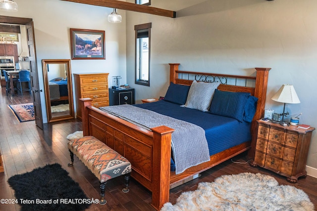 bedroom with dark hardwood / wood-style floors