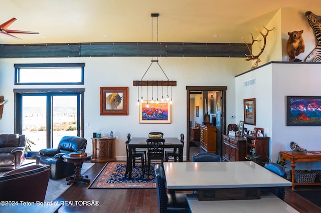 dining space featuring ceiling fan and dark hardwood / wood-style flooring