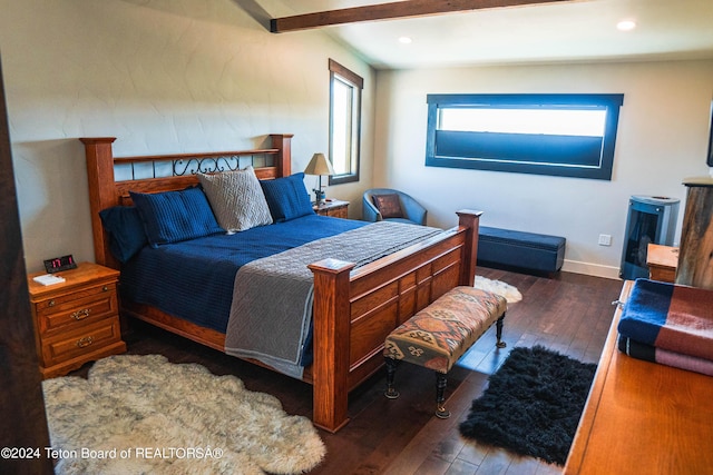 bedroom with dark hardwood / wood-style flooring and beamed ceiling