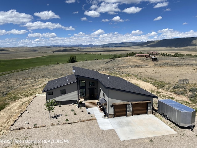 drone / aerial view featuring a rural view and a mountain view