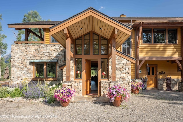 155 E Buck Mountain Rd, Jackson, WY 83001 - entrance to property with stone siding and a chimney