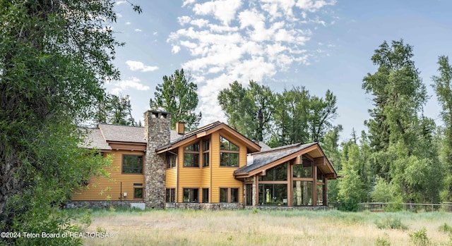 155 E Buck Mountain Rd, Jackson, WY 83001 - back of house featuring a chimney and roof with shingles