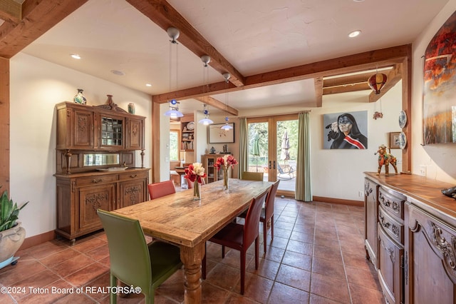 tiled dining room with beamed ceiling and french doors